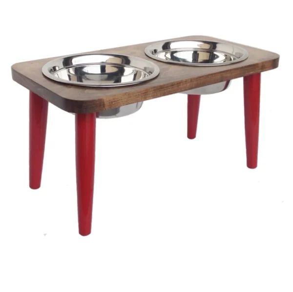 A wooden table with two stainless steel bowls on top.