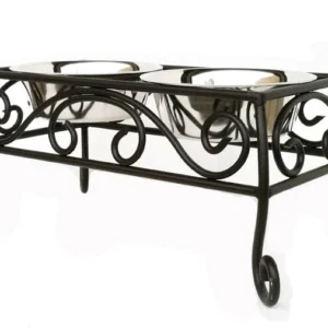 A wrought iron table with two bowls on top.
